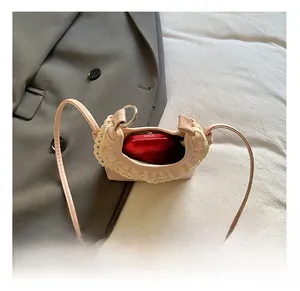 Detailed interior of a pink mini crossbody bag with lace trim showing lipstick storage