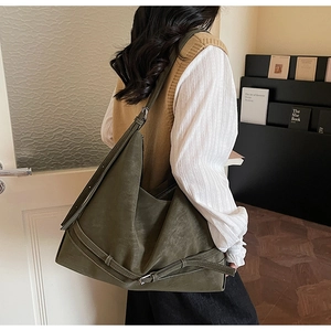 Detailed view of olive green suede tote bag with metal buckle and soft retro structure