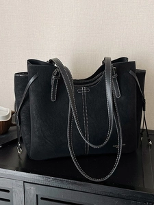 Large black suede tote bag with contrast stitching and adjustable straps for women