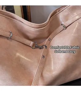 Detailed view of large capacity tote bag featuring soft pleated PU leather and metal hooks