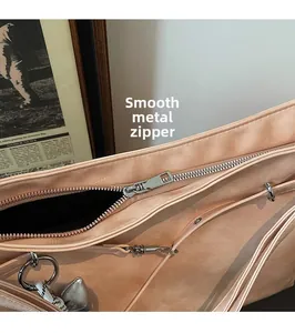 Detailed macro shot of the smooth silver zipper and matte beige leather bag texture