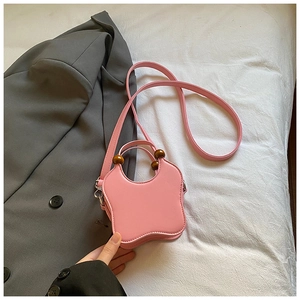 Pink butterfly-shaped PU leather bag with beaded handle and shoulder strap detail