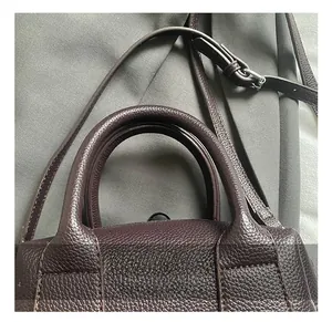 Close-up of litchi texture leather handbag with silver hardware and detailed stitching