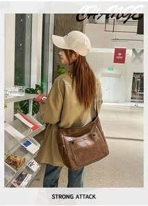Detail of a brown PU leather crossbody bag with natural texture and front flap pocket