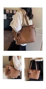 Detail view of caramel brown pebbled leather tote bag with a cute plush bear charm