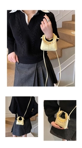 Detailed views of mini yellow lipstick bag with ruffled trim and glossy patent finish