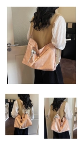Detail of hobo bag in soft leather with bow pendant and striped rope decoration