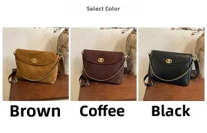 Detailed view of quilted chain bags in brown, coffee, and black on a wooden table
