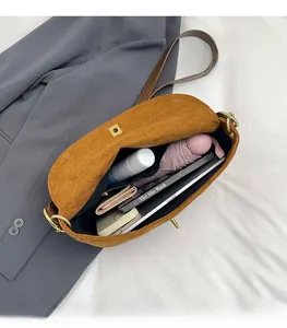 Internal view of brown suede crossbody bag showing spacious capacity for daily essentials