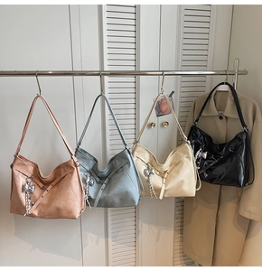 Detailed display of four large hobo tote bags with silver bow charms in multiple colors