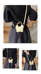 Detail of yellow flower shaped bucket bag with wooden beads and a slim shoulder strap