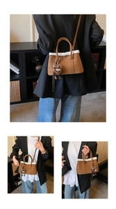 Detail view of brown suede tote with white faux fur trim and cute plush monster charm
