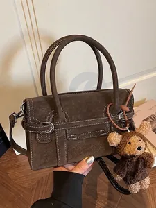 Brown suede tote bag with white stitching, silver buckles and a cute teddy bear charm