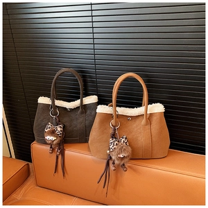 Detail of retro tote bags with faux shearling trim and leopard bow charms in rich brown tones