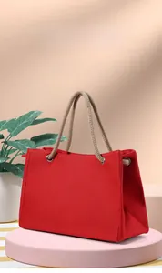 Detail view of red linen tote bag showing durable fabric texture and cotton rope handles