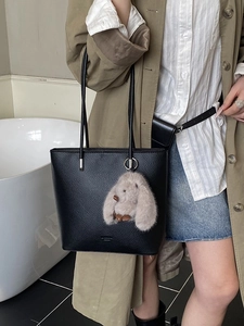 Fashionable black lychee leather tote bag for women with a cute plush rabbit pendant