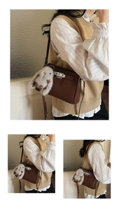 Detail of vintage brown leather handbag with silver twist lock and plush rabbit pendant