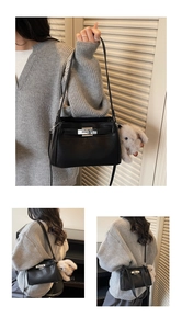 Detail of black leather crossbody bag with silver twist lock and plush rabbit charm