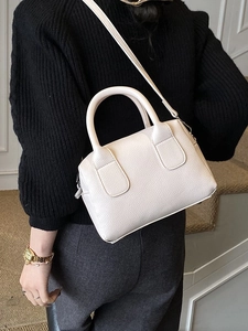 Vintage cream-colored lychee leather boston handbag with top handles and shoulder strap
