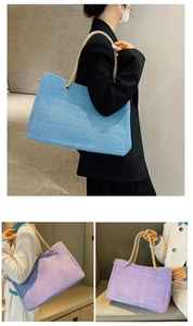 Detailed view of woven tote bag featuring thick rope handles and spacious interior design