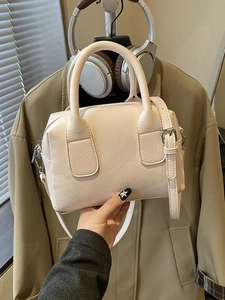 Off-white vintage bowling bag with litchi grain leather and adjustable strap
