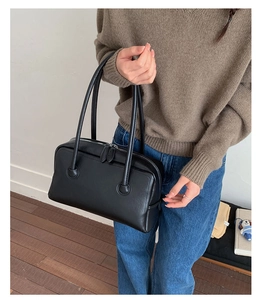 Black leather Boston bag with long top handles and vintage shoulder pillow bag style