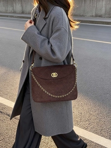 Dark brown suede messenger bag with quilted diamond pattern and gold chain strap