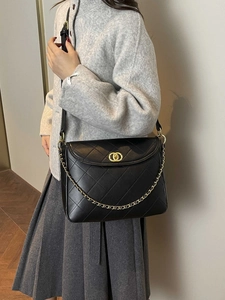 Classic black quilted leather messenger bag with gold chain strap and elegant clasp