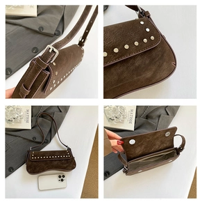 Detail of dark brown suede crossbody bag featuring silver rivets and adjustable strap