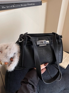 Vintage black leather Kelly bag for women with silver buckle and plush bunny charm
