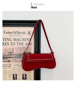 Detail of red leather underarm bag with silver rivet studs and vintage aesthetic