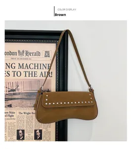 Detail view of brown PU leather shoulder bag featuring silver stud rivets and a wavy base