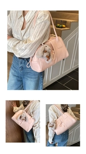 Detail view of pink PU leather tote bag with a cute plush bunny charm and shoulder straps