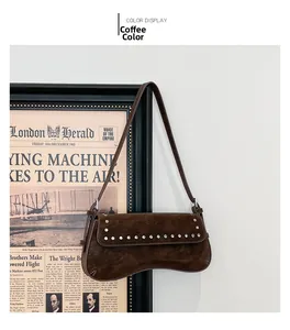 Macro detail of dark brown retro shoulder bag featuring silver rivet trim and matte leather
