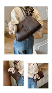 Detail of dark brown leather bowling tote bag featuring a cute plush bunny charm