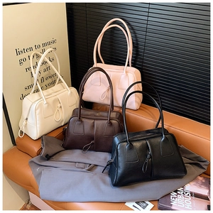 Detail showing the shoulder bag collection in white, pink, brown, and black colors