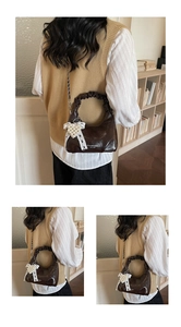Detail of a coffee brown crescent bag with pleated handle and white lace pearl bow charm