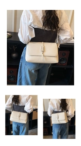 Close-up of white lychee pattern shoulder bag with a vintage metallic vertical buckle