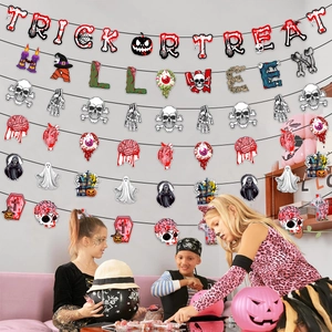 Close-up of Trick or Treat Halloween banner with ghost and skull hanging decorations