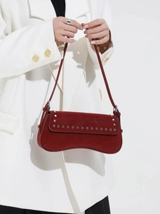 Vintage dark red suede baguette bag with silver studs and curved bottom on model