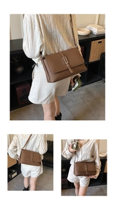 Detail shots of brown lychee grain leather crossbody bag with metal buckle closure