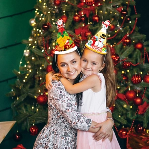 Close-up of festive paper Christmas party hats featuring Santa and snowman designs