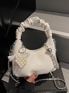 White pleated leather handbag with pearl heart pendant and metal chain strap