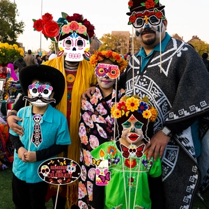 Day of the Dead photo booth props kit with colorful Mexican party masks and handheld signs