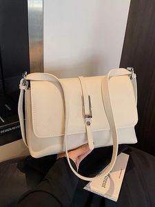 Creamy beige lychee leather rectangular crossbody bag with silver buckle and thin strap