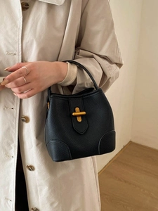Elegant black lychee leather bucket bag with gold T-bar metal lock and top handle