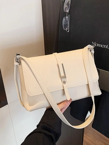Creamy white litchi pattern leather shoulder bag with silver metal buckle closure