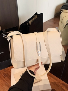 Minimalist beige pebble leather crossbody square bag with elegant silver buckle closure