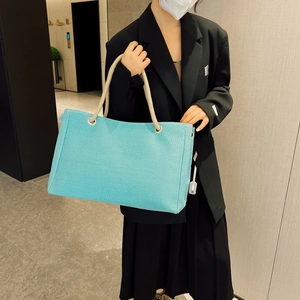 Close-up of sky blue canvas tote bag featuring stylish white and brown rope handles
