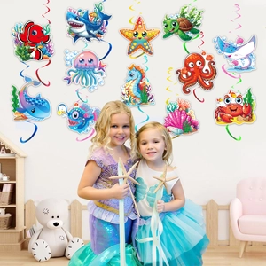 Ocean theme party hanging swirls featuring colorful sea creature cards and decorations